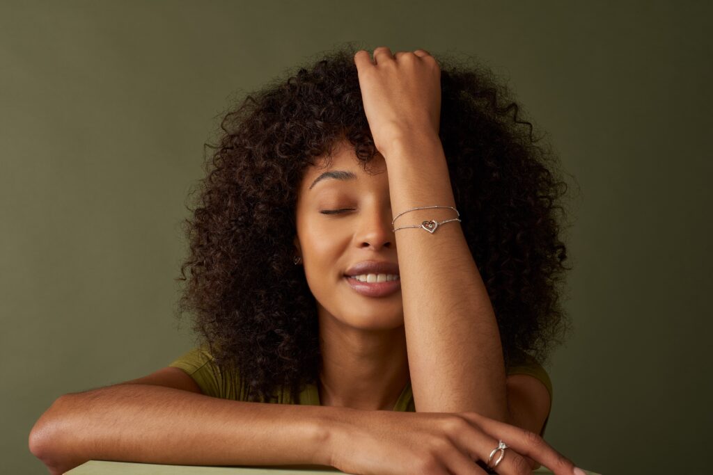 A model wearing a Clogau bracelet and ring.