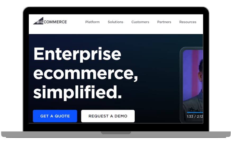 A laptop displaying the BigCommerce homepage.